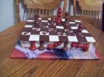 All chocolate... chess pieces and chess board made of chocolate: white, red and brown